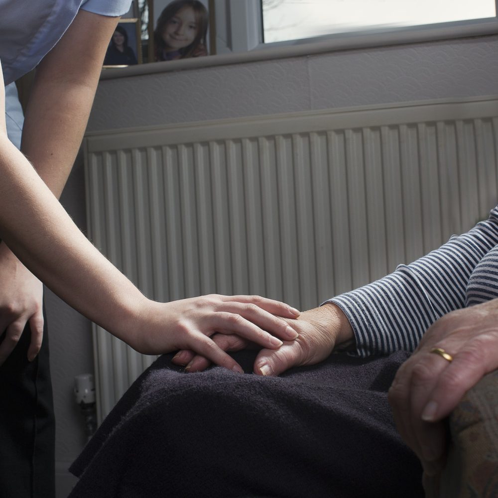 personal-care-assistant-comforting-senior-woman.jpg